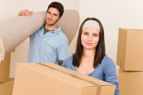 Local movers unloading boxes and furniture at a Dulwich property
